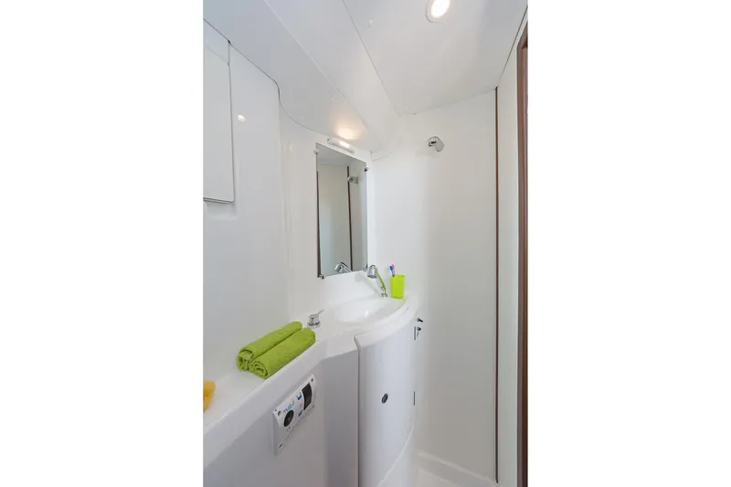  Yacht Photos Pics Bathroom interior of 2017 Lagoon 380 S2 yacht with modern fixtures and green towels.