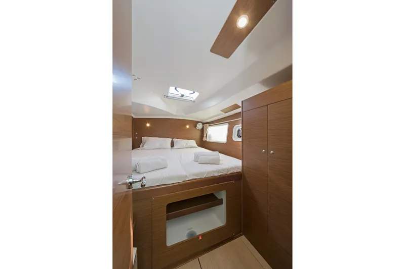 Yacht Photos Pics Luxurious cabin interior of 2017 Lagoon 380 S2 yacht with cozy bed and wooden finish.