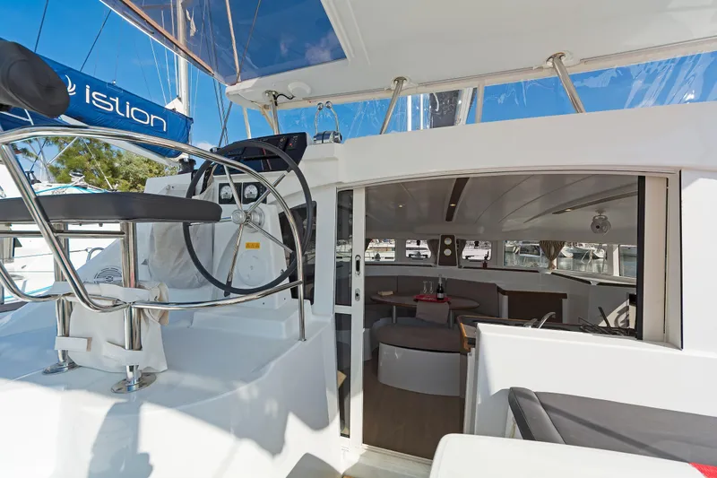  Yacht Photos Pics Lagoon 380 S2 2017 catamaran cockpit and interior view with helm station and seating area.