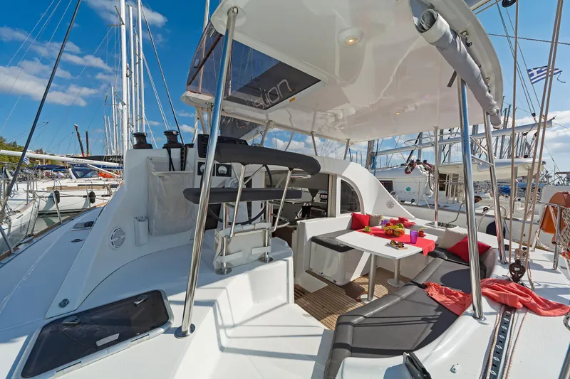  Yacht Photos Pics 2017 Lagoon 380 S2 catamaran with spacious deck, seating area, and vibrant cushions in marina.