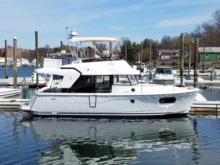  Yacht Photos Pics 2019 Beneteau Swift Trawler 35 docked at a marina, showcasing sleek design and modern features.