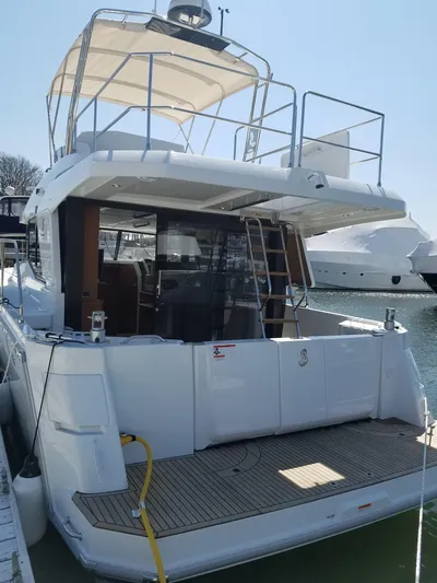  Yacht Photos Pics 2019 Beneteau Swift Trawler 35 docked, showcasing spacious deck and modern design.