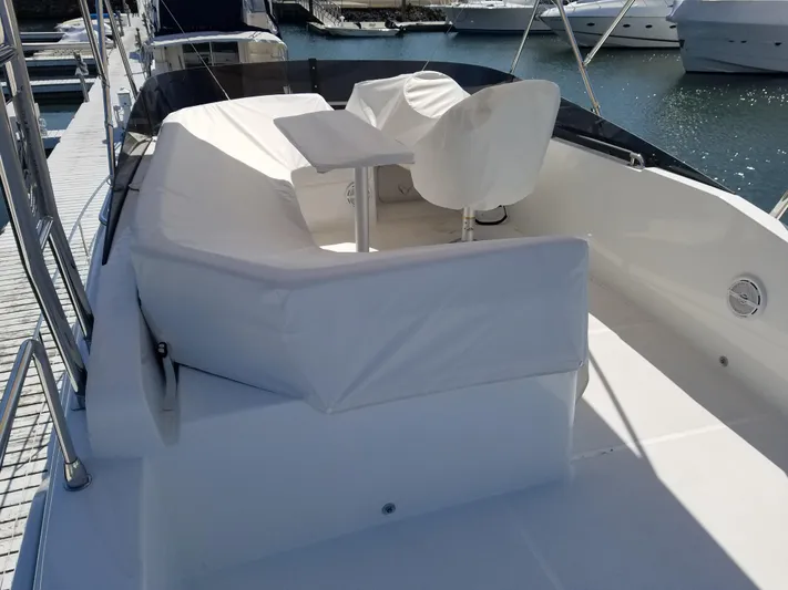  Yacht Photos Pics 2019 Beneteau Swift Trawler 35, featuring a sleek deck with white seating and table.