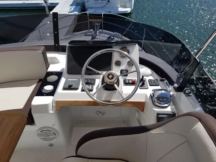  Yacht Photos Pics Cockpit of 2019 Beneteau Swift Trawler 35 with steering wheel and navigation controls.