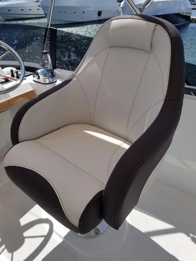  Yacht Photos Pics Captain's chair on 2019 Beneteau Swift Trawler 35, featuring sleek design and comfortable upholstery.