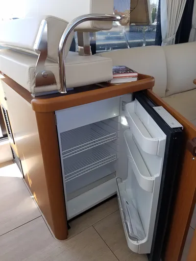  Yacht Photos Pics 2019 Beneteau Swift Trawler 35 interior with open mini fridge and modern sink.