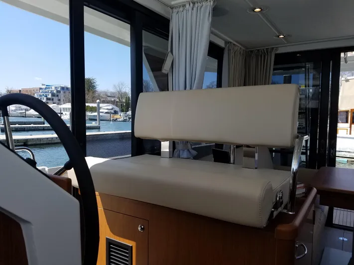  Yacht Photos Pics 2019 Beneteau Swift Trawler 35 interior with beige seating and marina view.
