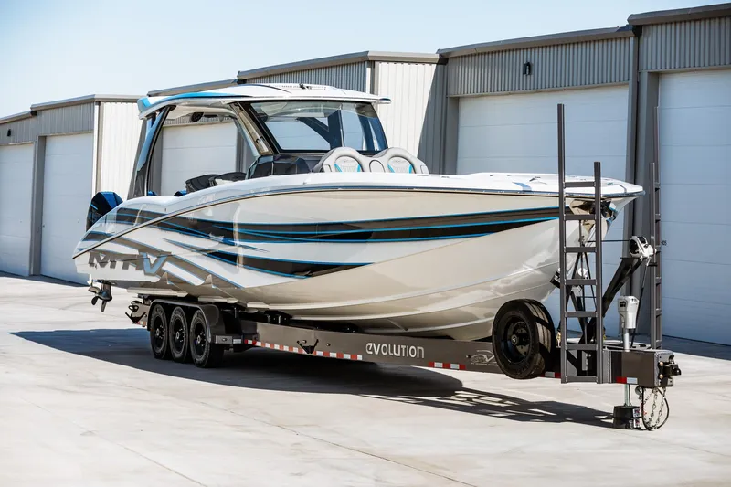  Yacht Photos Pics 2023 MTI V42 boat on a trailer in front of storage units.
