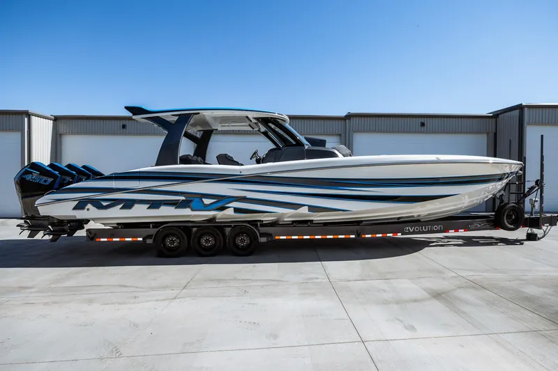  Yacht Photos Pics 2023 MTI V42 boat on a trailer in front of a warehouse.