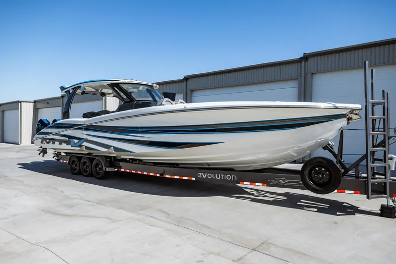  Yacht Photos Pics 2023 MTI V42 boat on a trailer in front of storage units.