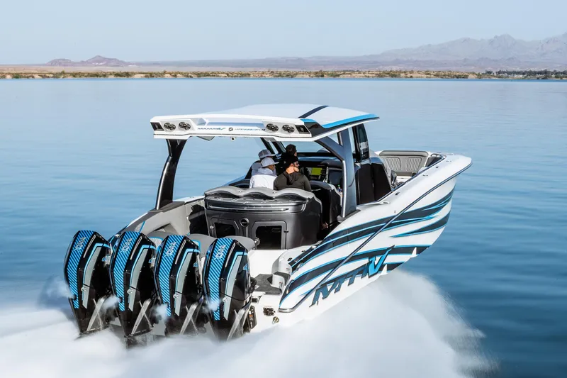  Yacht Photos Pics 2023 MTI V42 boat with four powerful outboard engines cruising on a lake.