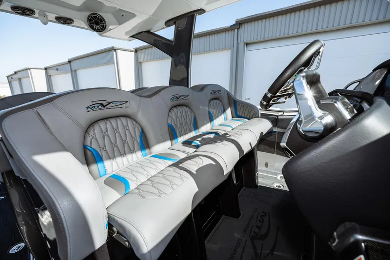  Yacht Photos Pics 2023 MTI V42 boat interior with luxurious seating and modern steering console.