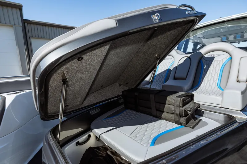  Yacht Photos Pics 2023 MTI V42 boat with open storage compartment and cushioned seating.