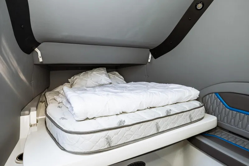  Yacht Photos Pics 2023 MTI V42 boat cabin with a cozy bed and modern interior.