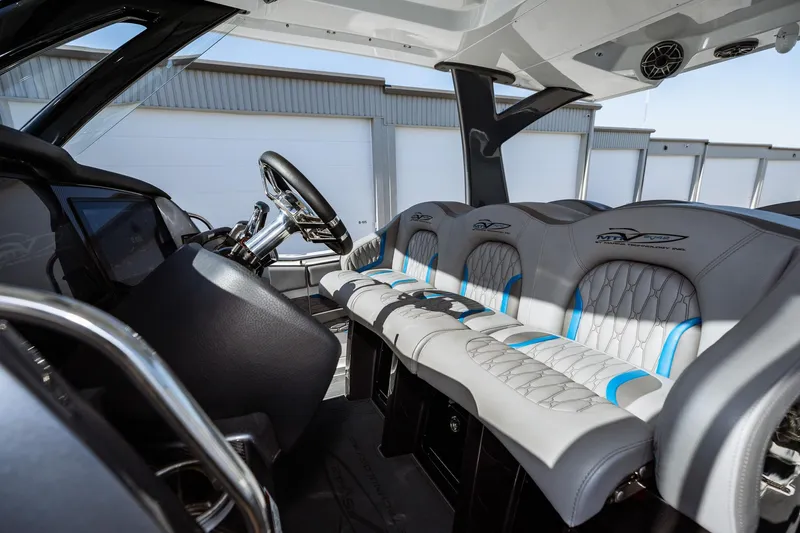  Yacht Photos Pics 2023 MTI V42 boat interior with modern seating and steering wheel.