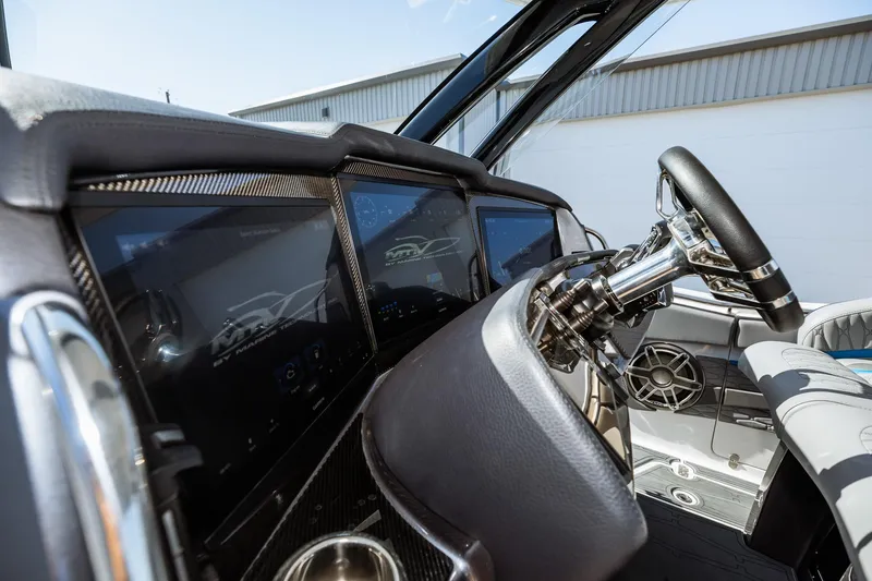  Yacht Photos Pics 2023 MTI V42 boat dashboard with advanced navigation screens and steering wheel.