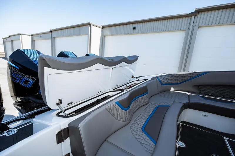  Yacht Photos Pics 2023 MTI V42 boat interior with gray and blue seating, open storage compartment.