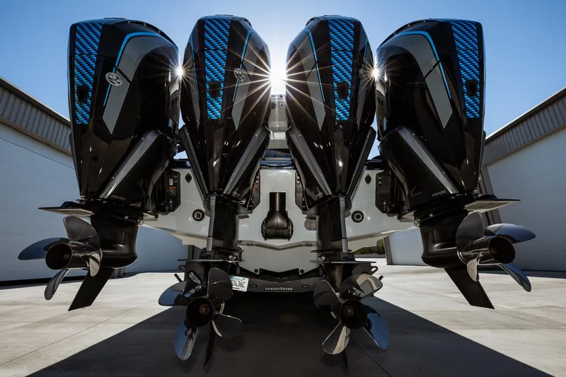  Yacht Photos Pics 2023 MTI V42 boat with four powerful outboard engines in a marina.