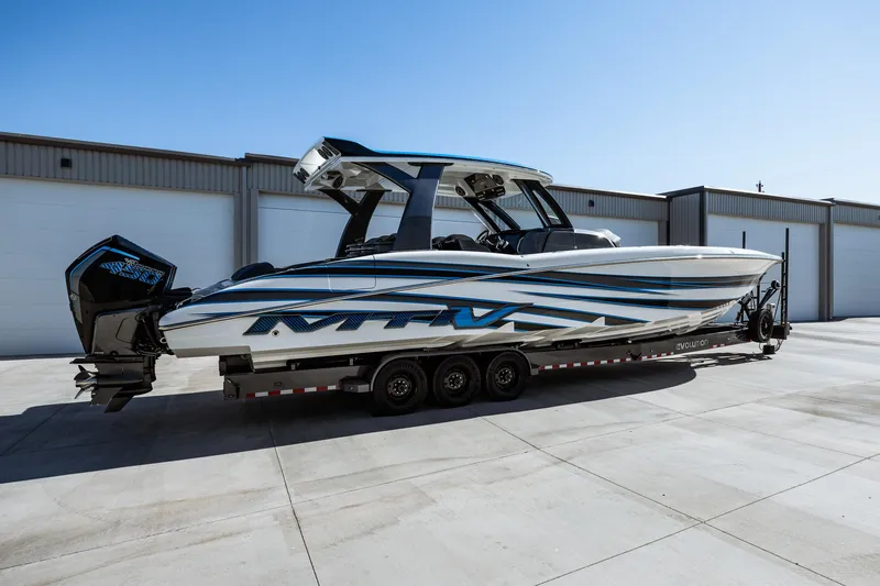  Yacht Photos Pics 2023 MTI V42 boat on a trailer in front of a warehouse.