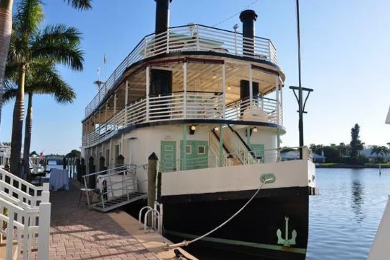 Indian River Queen Yacht Photos Pics Custom 1984 paddle wheel boat docked by palm trees on a sunny day.