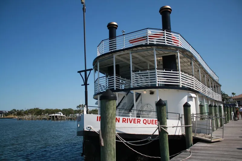 Indian River Queen Yacht Photos Pics Custom 1984 paddle wheel boat docked, named "Indian River Queen," under clear blue sky.