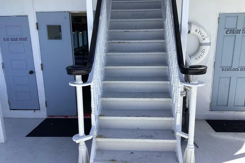 Indian River Queen Yacht Photos Pics Staircase on 1984 custom paddle wheel boat with life jacket locker and lifebuoy.