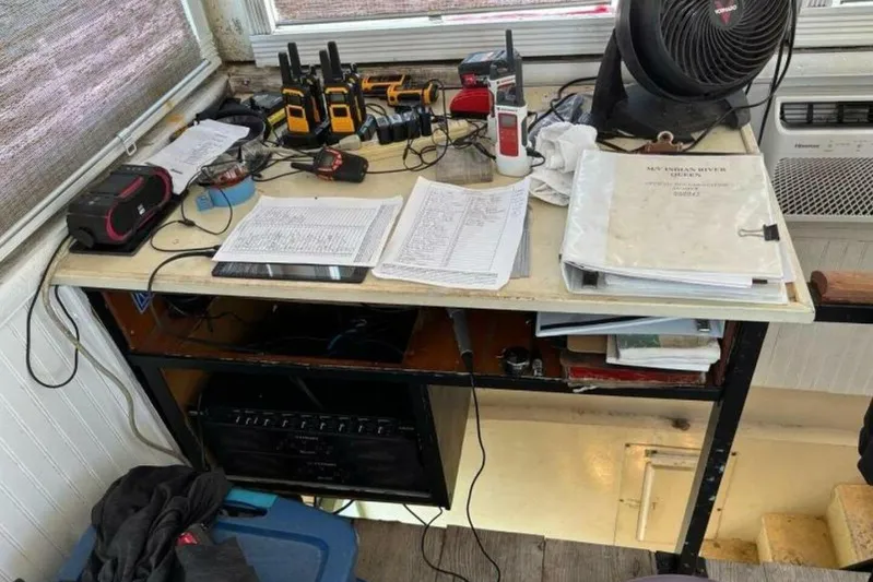 Indian River Queen Yacht Photos Pics Desk with communication devices, fan, and documents on a Custom Paddle Wheel, 1984 model.