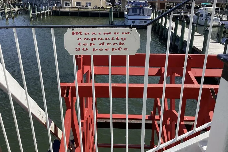 Indian River Queen Yacht Photos Pics Red paddle wheel boat with capacity sign, docked at marina, Custom Paddle Wheel 1984.