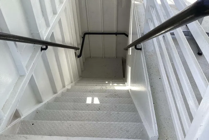 Indian River Queen Yacht Photos Pics Staircase on 1984 Custom Paddle Wheel boat with white metal railings and steps.