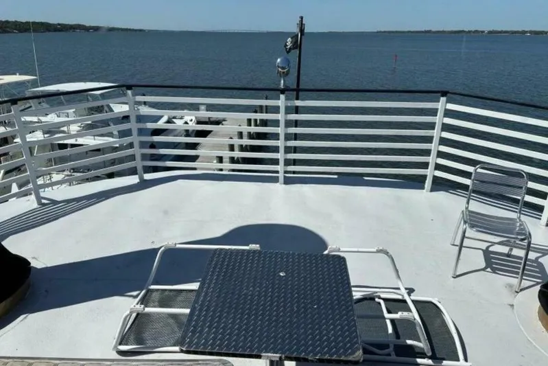 Indian River Queen Yacht Photos Pics Rooftop deck of a 1984 Custom Paddle Wheel boat overlooking a serene waterfront.