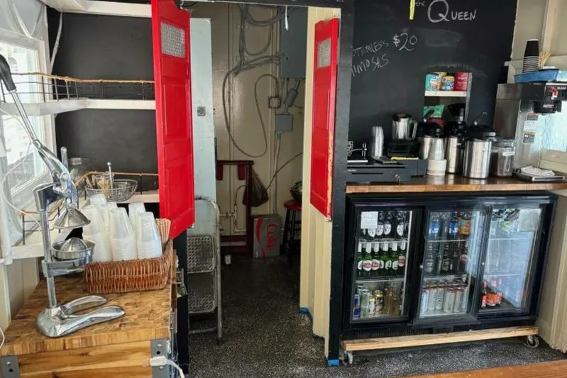 Indian River Queen Yacht Photos Pics Cozy cafe interior with beverage station, red doors, and stocked drink fridge. Custom Paddle Wheel, 1984.