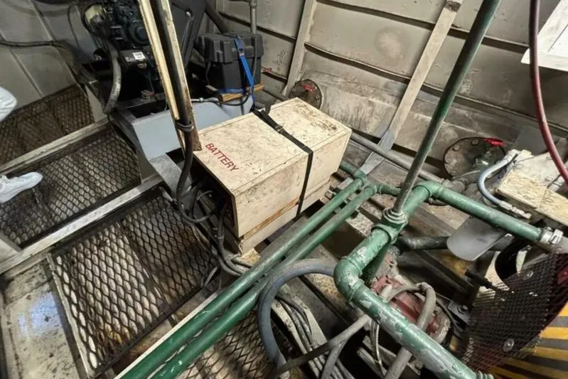 Indian River Queen Yacht Photos Pics Engine room of a 1984 Custom Paddle Wheel boat with visible battery and machinery.