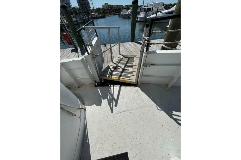 Indian River Queen Yacht Photos Pics Boat deck with ramp leading to dock, Custom Paddle Wheel, 1984, marina view.
