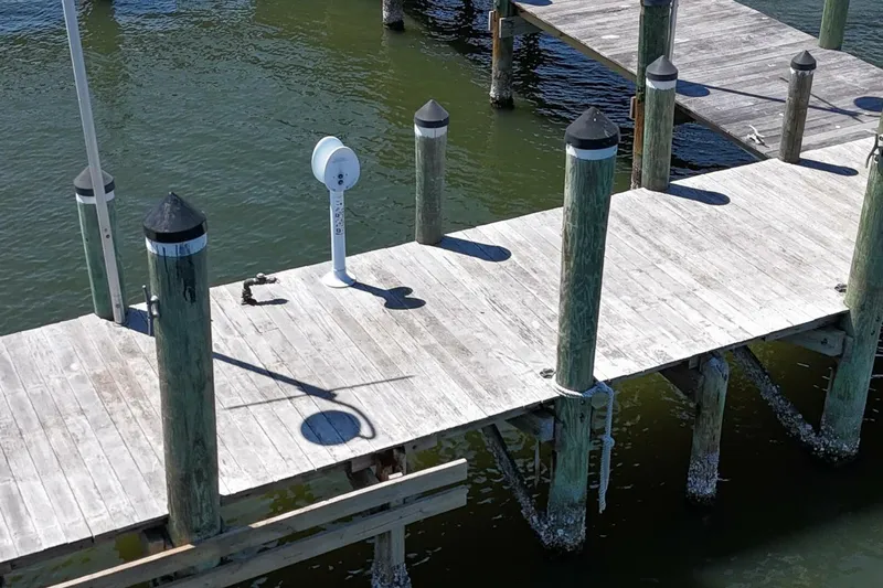 Indian River Queen Yacht Photos Pics Wooden dock with green water, featuring a Custom Paddle Wheel from 1984.