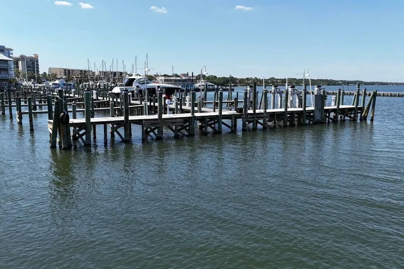 Indian River Queen Yacht Photos Pics Marina with wooden docks and boats under a clear blue sky.