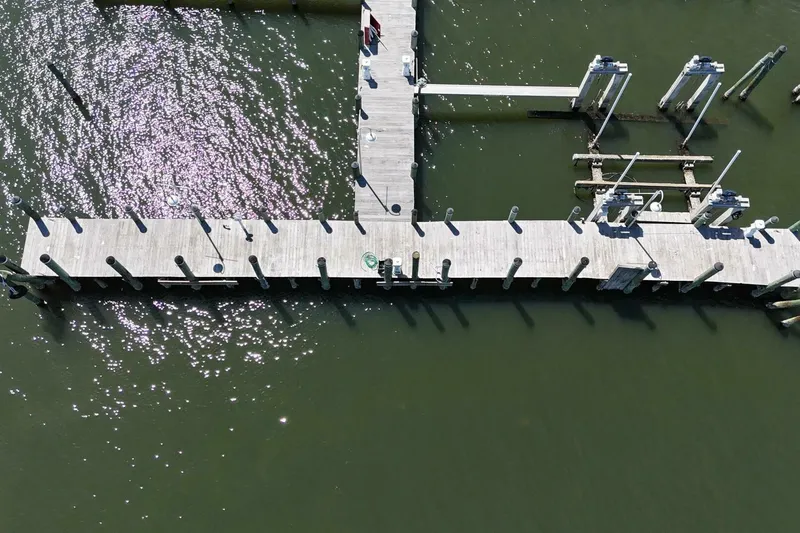 Indian River Queen Yacht Photos Pics Aerial view of wooden dock over green water, Custom Paddle Wheel, 1984.
