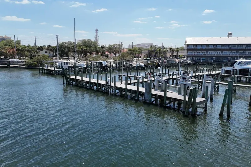 Indian River Queen Yacht Photos Pics Marina with docks and boats under a clear blue sky, Custom Paddle Wheel, 1984.