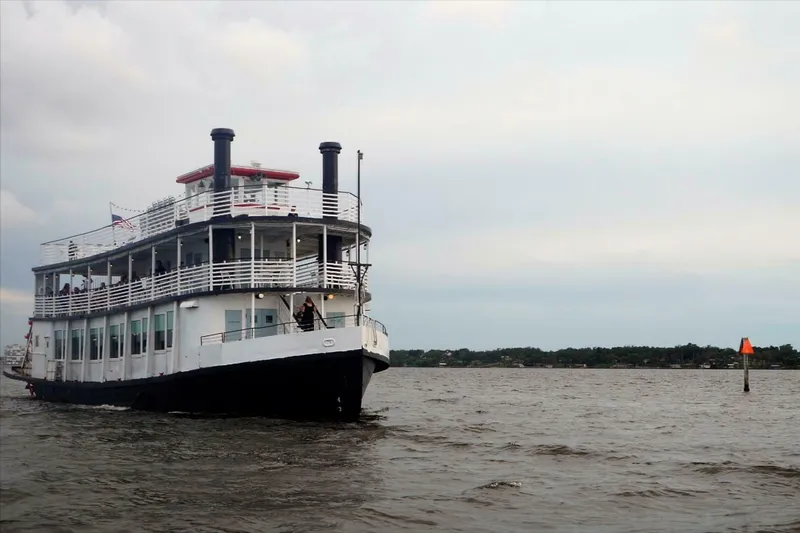 Indian River Queen Yacht Photos Pics Custom 1984 paddle wheel boat cruising on a calm river under a cloudy sky.