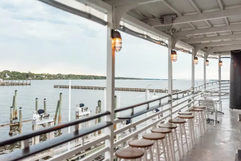 Indian River Queen Yacht Photos Pics Scenic river view from a 1984 custom paddle wheel boat deck with stools and hanging lights.