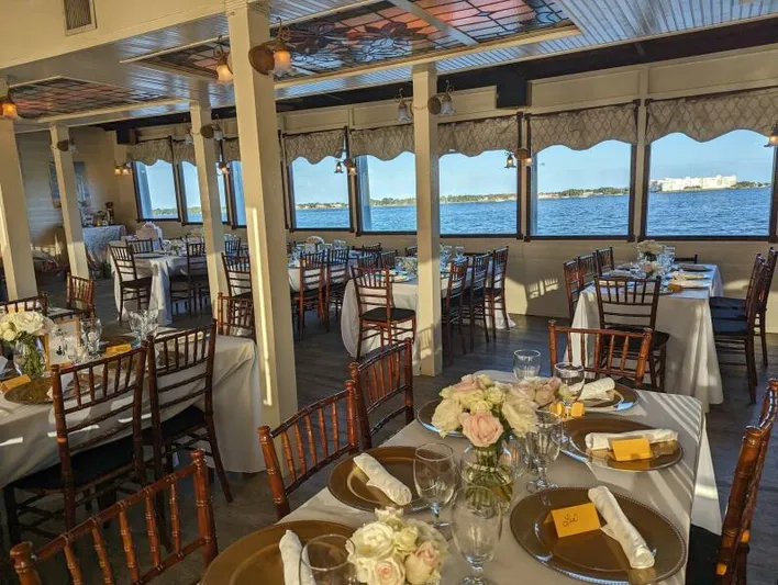 Indian River Queen Yacht Photos Pics Elegant dining setup on a 1984 custom paddle wheel boat with scenic water views.
