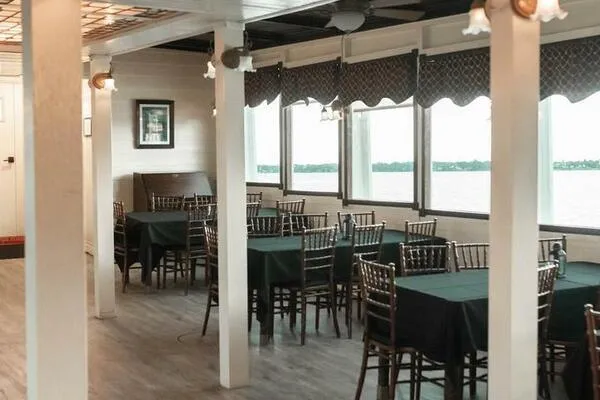 Indian River Queen Yacht Photos Pics Interior of a 1984 custom paddle wheel boat with dining tables and river view.