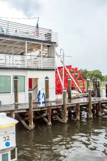 Indian River Queen Yacht Photos Pics Vintage 1984 custom paddle wheel boat docked at a wooden pier.