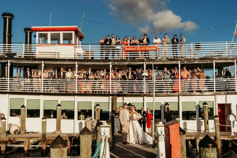 Indian River Queen Yacht Photos Pics Wedding party on 1984 Custom Paddle Wheel boat, "Indian River Queen," docked under a clear blue sky.
