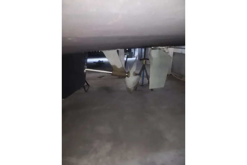 Teddy B Yacht Photos Pics 1997 Mainship 350 Trawler propeller and rudder in a dry dock setting.