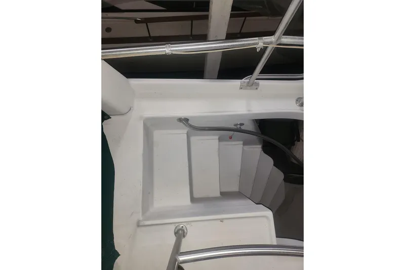 Teddy B Yacht Photos Pics 1997 Mainship 350 Trawler stairs with metal railing, viewed from above.