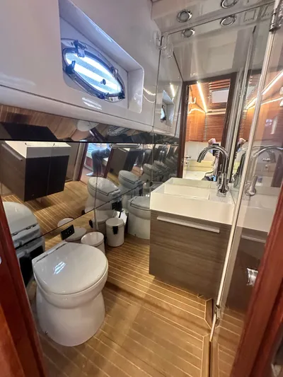  Yacht Photos Pics Luxurious bathroom in 2000 Pershing 54 yacht, featuring modern fixtures and wooden flooring.