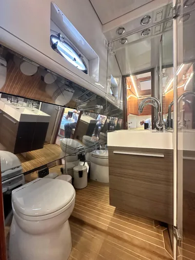  Yacht Photos Pics Luxury bathroom in 2000 Pershing 54 yacht, featuring modern fixtures and wood accents.