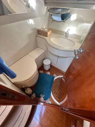  Yacht Photos Pics Luxurious bathroom in 2000 Pershing 54 yacht, featuring elegant fixtures and wooden accents.