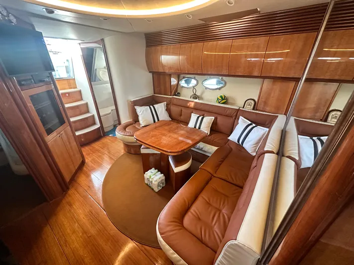  Yacht Photos Pics Luxurious interior of 2000 Pershing 54 yacht with elegant wood finishes and plush seating.