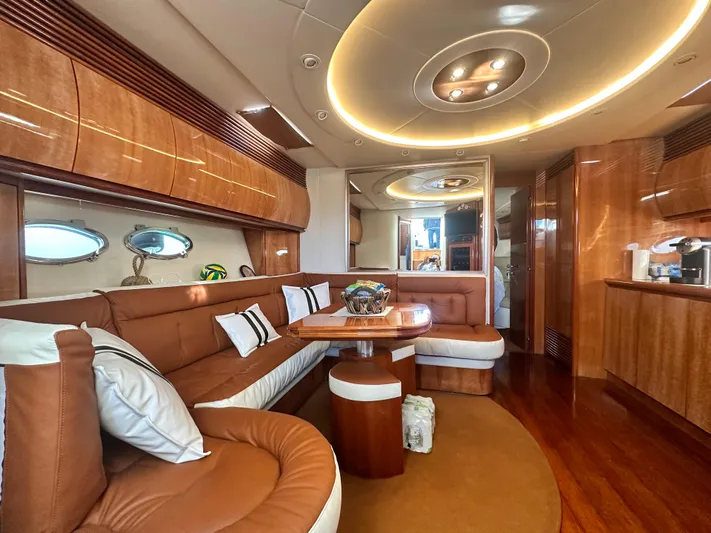  Yacht Photos Pics Luxurious interior of 2000 Pershing 54 yacht with elegant wood finishes and plush seating.